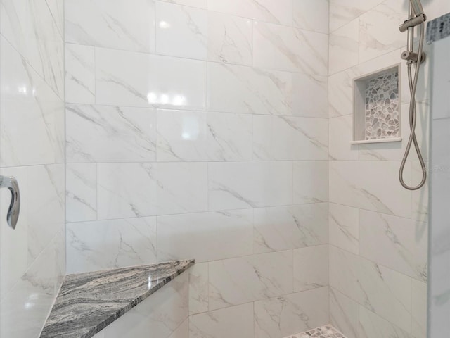 bathroom featuring tiled shower