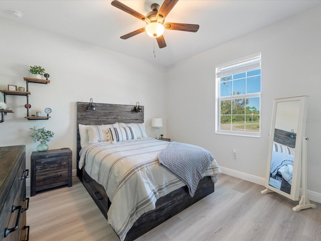 bedroom with light hardwood / wood-style floors and ceiling fan