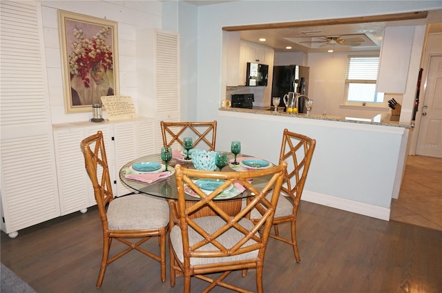 dining room with dark hardwood / wood-style floors and ceiling fan