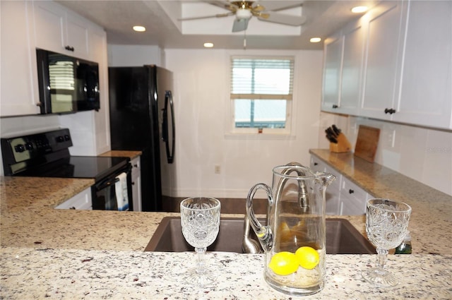 kitchen featuring light stone countertops, white cabinetry, ceiling fan, and black appliances