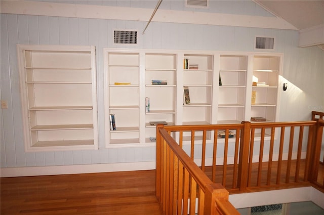 hall featuring dark hardwood / wood-style flooring and vaulted ceiling