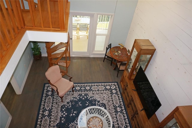 interior space with hardwood / wood-style floors and wood walls