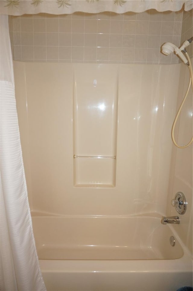 bathroom with shower / bathtub combination with curtain