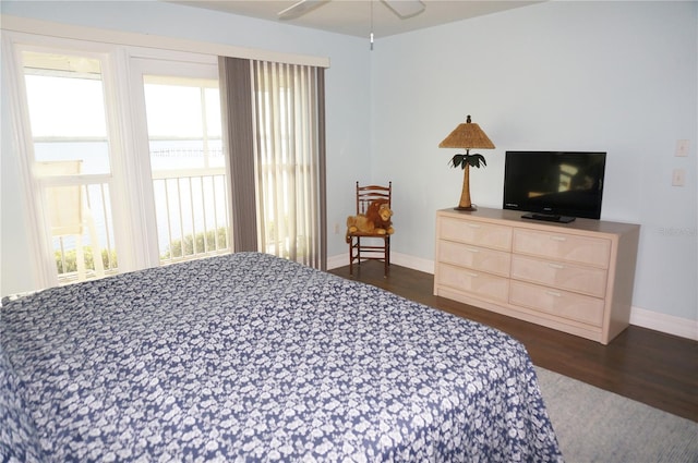 bedroom featuring dark hardwood / wood-style flooring, multiple windows, and ceiling fan