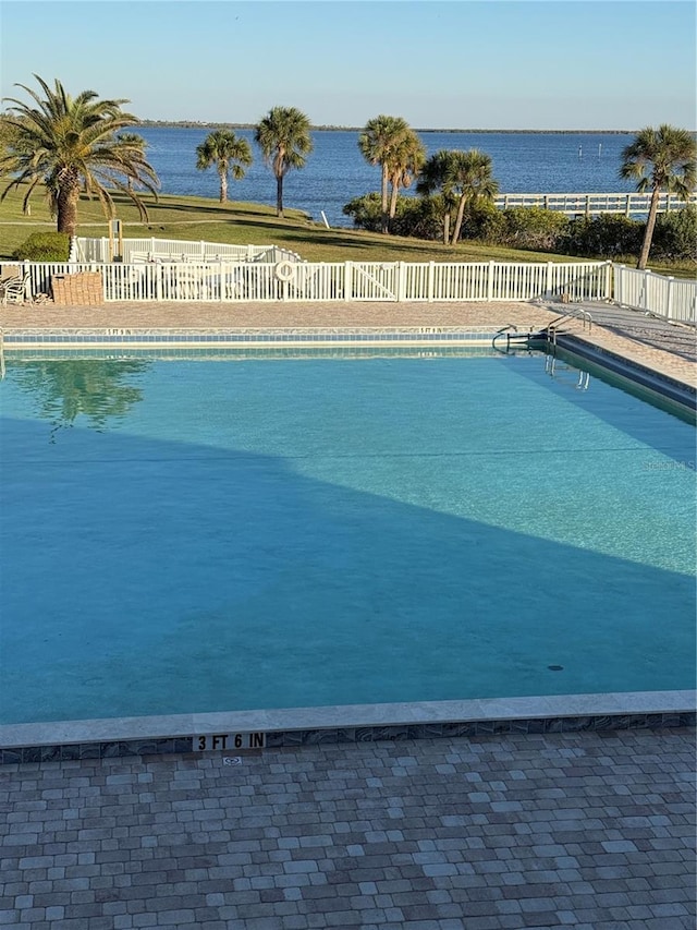 view of pool with a water view