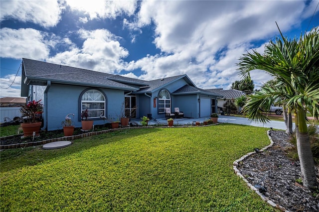 ranch-style home with a front yard and a garage