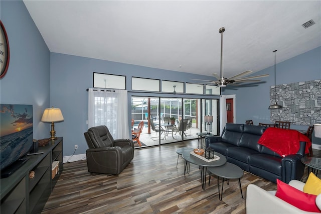 living room featuring vaulted ceiling, ceiling fan, and dark hardwood / wood-style floors