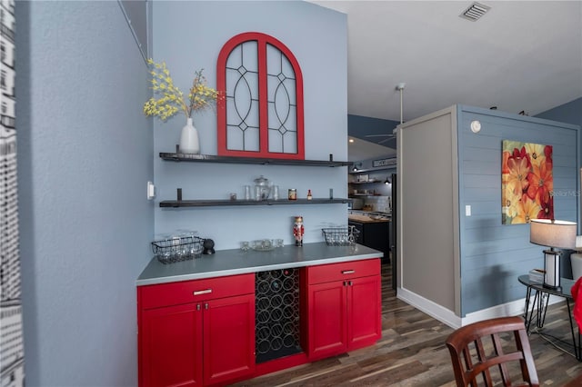 bar with dark hardwood / wood-style floors