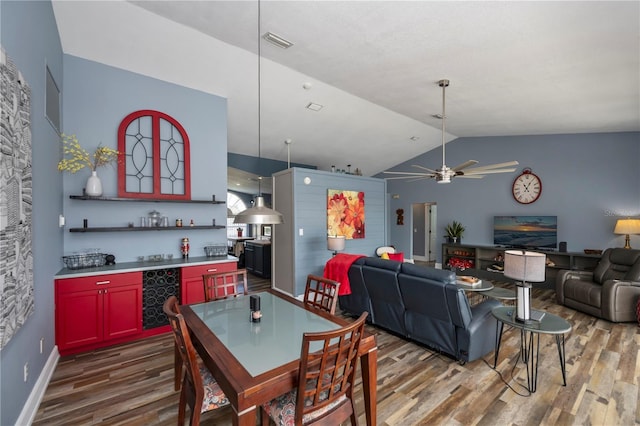 dining area featuring beverage cooler, dark wood-type flooring, ceiling fan, and lofted ceiling