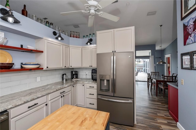 kitchen with decorative backsplash, dark hardwood / wood-style flooring, white cabinetry, and stainless steel appliances