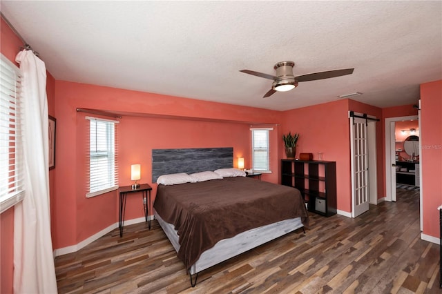 bedroom featuring a textured ceiling, dark hardwood / wood-style flooring, and ceiling fan