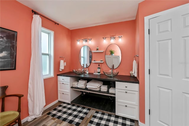 bathroom featuring vanity, wood-type flooring, and a wealth of natural light