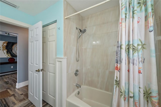 bathroom with shower / bath combo with shower curtain and wood-type flooring