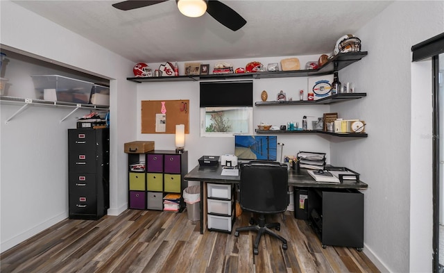 home office featuring dark hardwood / wood-style floors and ceiling fan