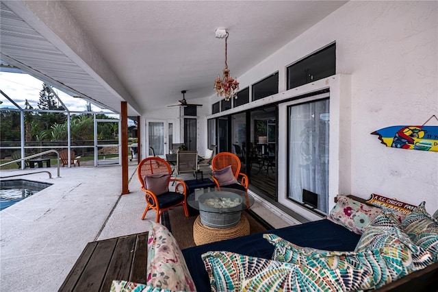 view of patio with glass enclosure and ceiling fan