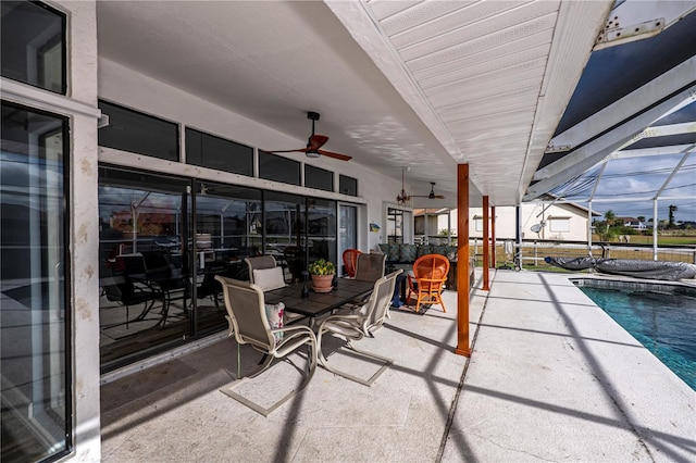 view of patio featuring a lanai and ceiling fan