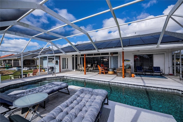 view of pool with a patio and glass enclosure