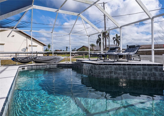 view of pool with glass enclosure and pool water feature