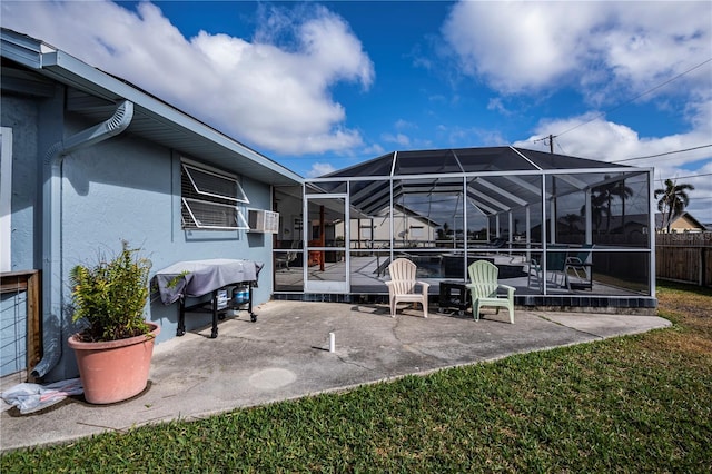 view of patio / terrace with glass enclosure and a grill