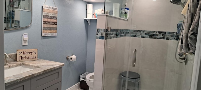 bathroom featuring vanity, toilet, and walk in shower