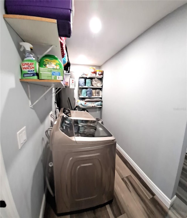 laundry area with wood-type flooring and washer / clothes dryer