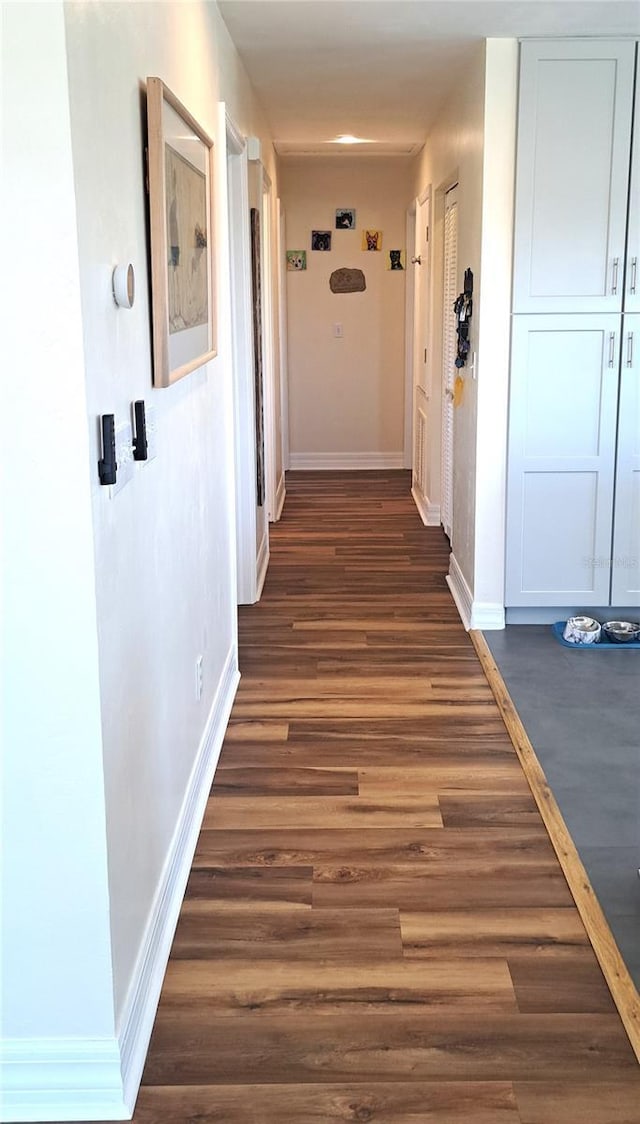 hall with dark hardwood / wood-style flooring