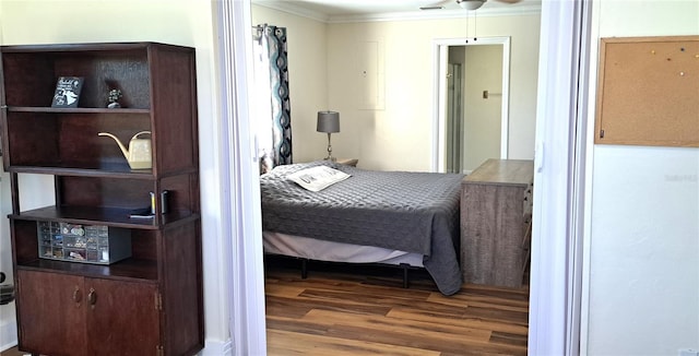 bedroom featuring dark hardwood / wood-style floors, ceiling fan, and crown molding