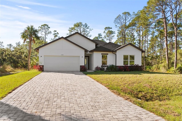 ranch-style home featuring a garage and a front lawn