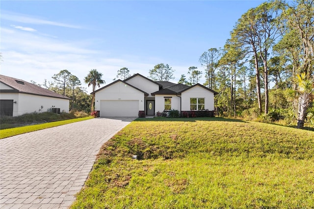 view of front facade with a garage and a front lawn