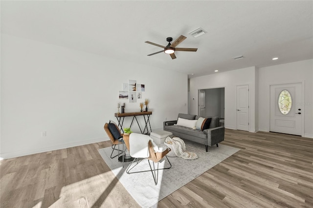 living room with ceiling fan and light hardwood / wood-style flooring