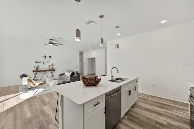 kitchen featuring white cabinets, a kitchen island with sink, sink, light hardwood / wood-style flooring, and dishwasher