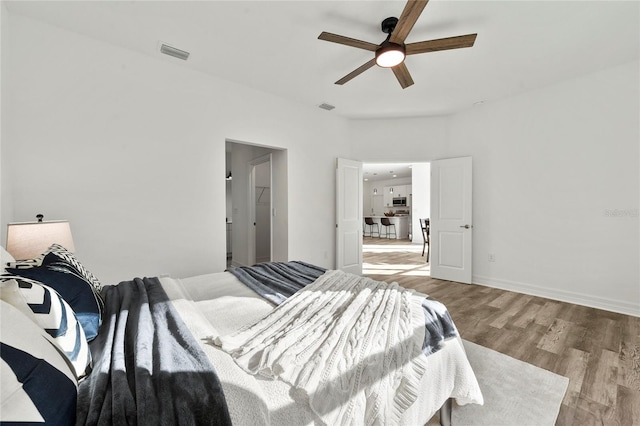 bedroom featuring light hardwood / wood-style floors and ceiling fan