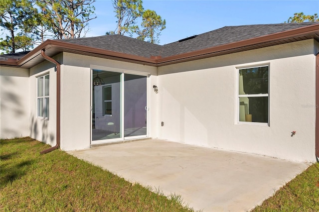 back of property featuring a yard and a patio