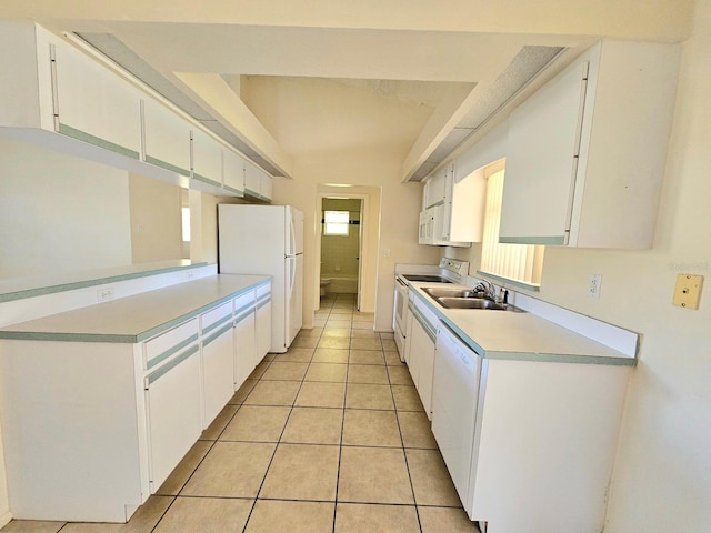 kitchen featuring light tile patterned floors, white cabinets, white appliances, and sink