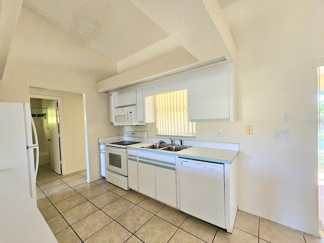 kitchen featuring white cabinetry, light tile patterned flooring, white appliances, and sink