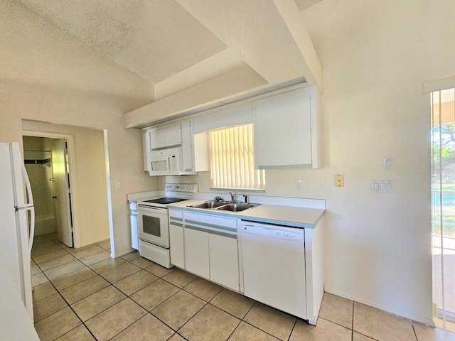 kitchen featuring white cabinetry, sink, a textured ceiling, white appliances, and light tile patterned floors