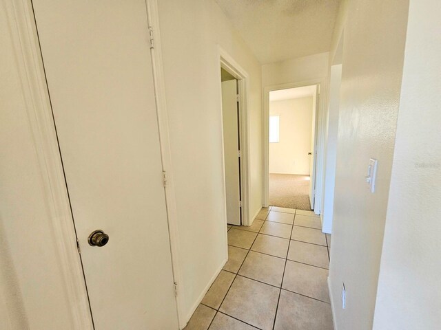 hallway featuring light tile patterned flooring