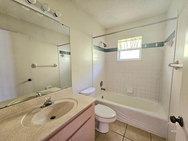 full bathroom featuring vanity, a textured ceiling, tile patterned flooring, toilet, and tiled shower / bath