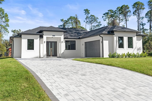 rear view of house with a yard and a garage