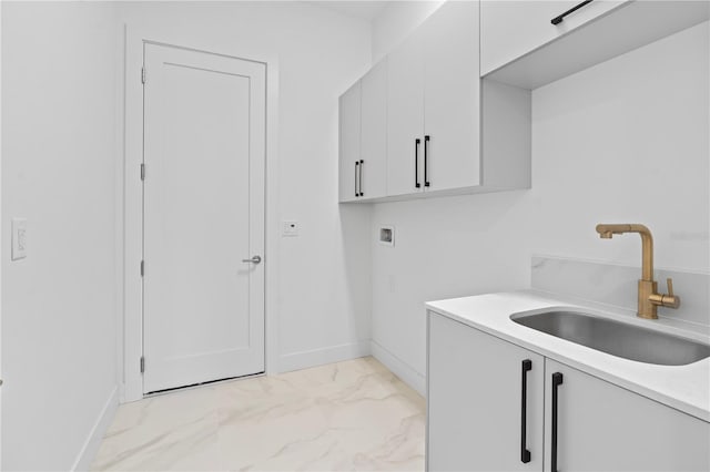 washroom with cabinets, sink, and hookup for a washing machine