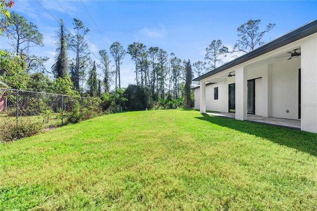 view of yard with a patio and ceiling fan