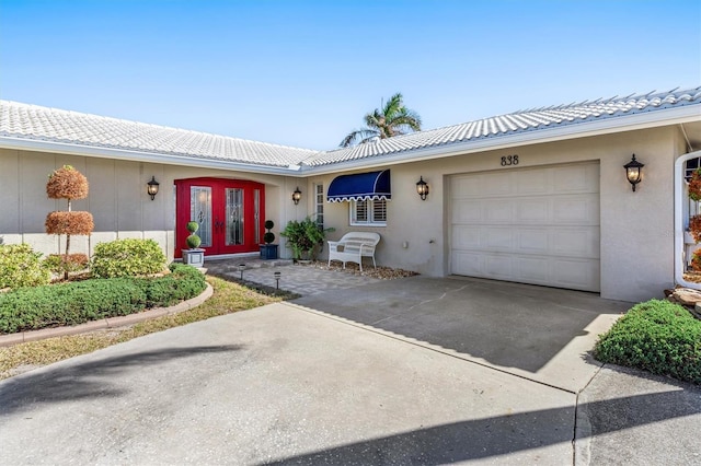 single story home with french doors and a garage