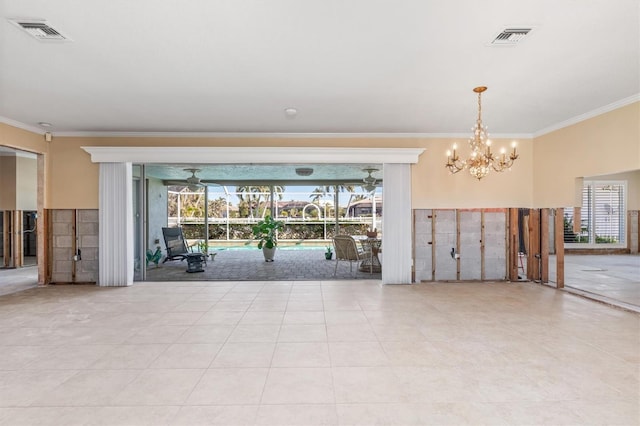 tiled empty room with ceiling fan with notable chandelier and crown molding