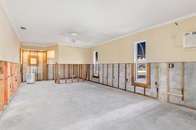 spare room with an AC wall unit, ceiling fan, and crown molding