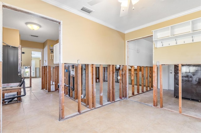 interior space with ceiling fan and crown molding