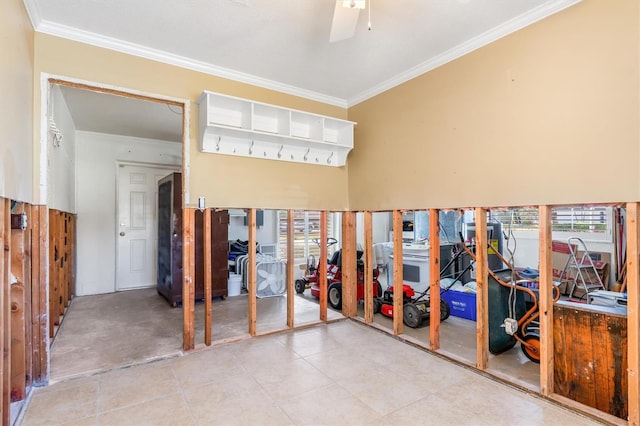 interior space with ceiling fan and crown molding