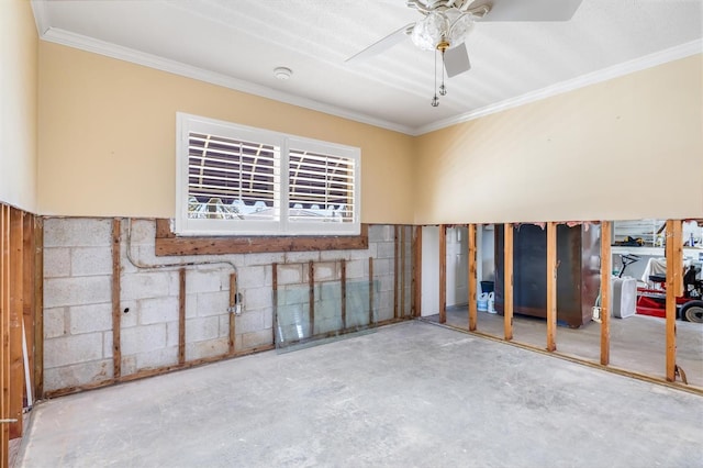 basement featuring ceiling fan and ornamental molding