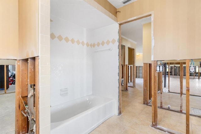 bathroom with a tub to relax in and tile patterned floors