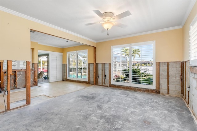 unfurnished room with ceiling fan, crown molding, and a wealth of natural light