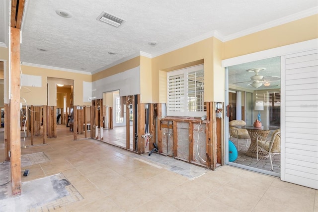 misc room with light tile patterned floors, a textured ceiling, ceiling fan, and ornamental molding